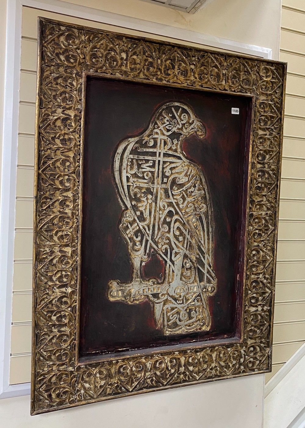 A rectangular hardwood panel decorated with an Arabian hawk, width 90cm, height 121cm